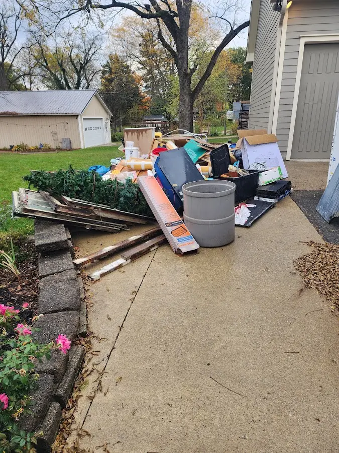 Dumpster being loaded with debris for Roofing Dumpster Rental in Westland